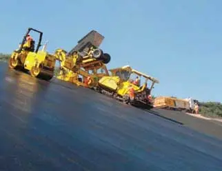 pavement workers working at night on a sideway road
